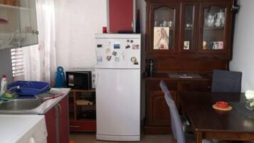 Apartment (One-Bedroom Apartment) | Private kitchen | Fridge