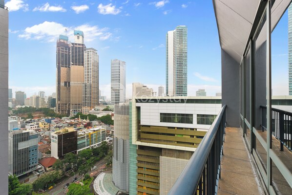 A high-rise building with a modern design, featuring large windows and a prominent sign. - Brassia by Kozystay - Thamrin (Jakarta)