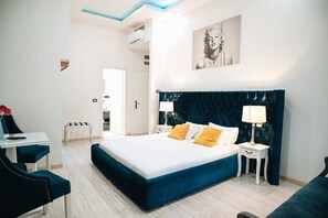A modern hotel room with a large bed, bedside tables, a desk, and a chair. - Escape Suite Guest House (Rome)