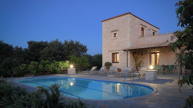 A stone building with a pool, lounge chairs, and a patio area. - Sarpedon & Rhadamanthus By Forest Villas (Rethymno)