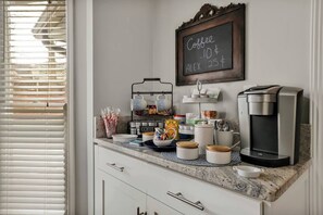 Enjoy a freshly brewed coffee at the kitchen's coffee station, complete with a chalkboard menu and all the essentials.