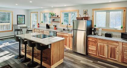 Brand new family home nestled in the woods close to Waterbury, Stowe, and Sugarbush with a hot tub