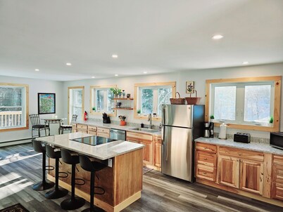 Brand new family home nestled in the woods close to Waterbury, Stowe, and Sugarbush with a hot tub