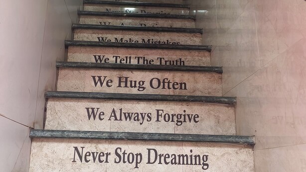 A staircase with motivational quotes on each step. - Green Apple PG & Dormitory (Mumbai)