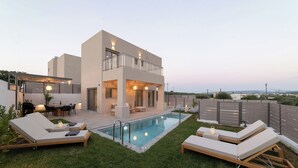 A modern two-story house with a swimming pool, outdoor seating, and a view of the landscape. - KS2 Exclusive Luxury Villa with 2 Bedrooms, Private Pool, BBQ &Outdoor Dining (Asprouliani)