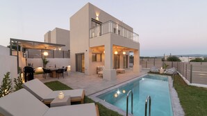 A modern two-story house with a swimming pool, outdoor seating, and a covered patio area. - KS2 Exclusive Luxury Villa with 2 Bedrooms, Private Pool, BBQ &Outdoor Dining (Asprouliani)