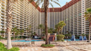 A hotel with multiple high-rise buildings, a swimming pool, and palm trees. - Sea and Ski: 1BR+ Bunk/2BA, Direct Gulf Views! Shores of Panama (Panama City Beach)