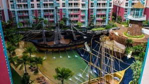 A water park with a pirate ship, palm trees, and a pool. - GSR - Grande Caribbean (Pattaya)