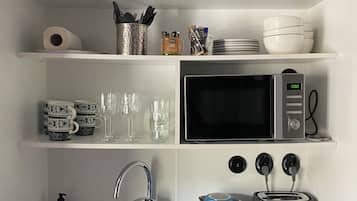 Deluxe Quadruple Room, City View | Private kitchen | Fridge, microwave, high chair