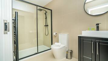 Shower, hair dryer, towels, shampoo