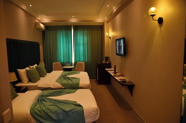 Family Room, Courtyard View | Free minibar, desk, blackout drapes, iron/ironing board