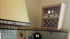 A compact kitchen with a gas stove, a coffee maker, and a sink. - Rose de Picardie in BAIE DE SOMME 3 minutes from the beach and shops (Cayeux-sur-Mer)