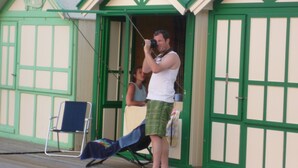 A man taking a photo with a camera in front of a building labeled "HURT" and "BRIGHTON". - Rose de Picardie in BAIE DE SOMME 3 minutes from the beach and shops (Cayeux-sur-Mer)