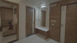 Un bagno moderno con porte in legno, uno specchio e una panca.