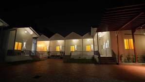 A series of connected buildings with multiple windows and a paved courtyard. - Brij Hari Villa (Varanasi)