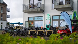 A row of bicycles parked outside a building with a sign reading "Tourguide." - Apartment 23 - 1-room apartment, TV, shower, terrace (Kappeln)