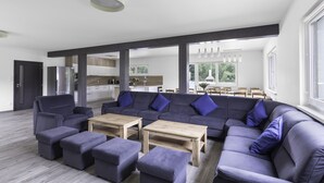 A modern living room with a sectional sofa, ottomans, and wooden coffee tables. - Prosence Kpa250 in Prosecn (Prosečné)