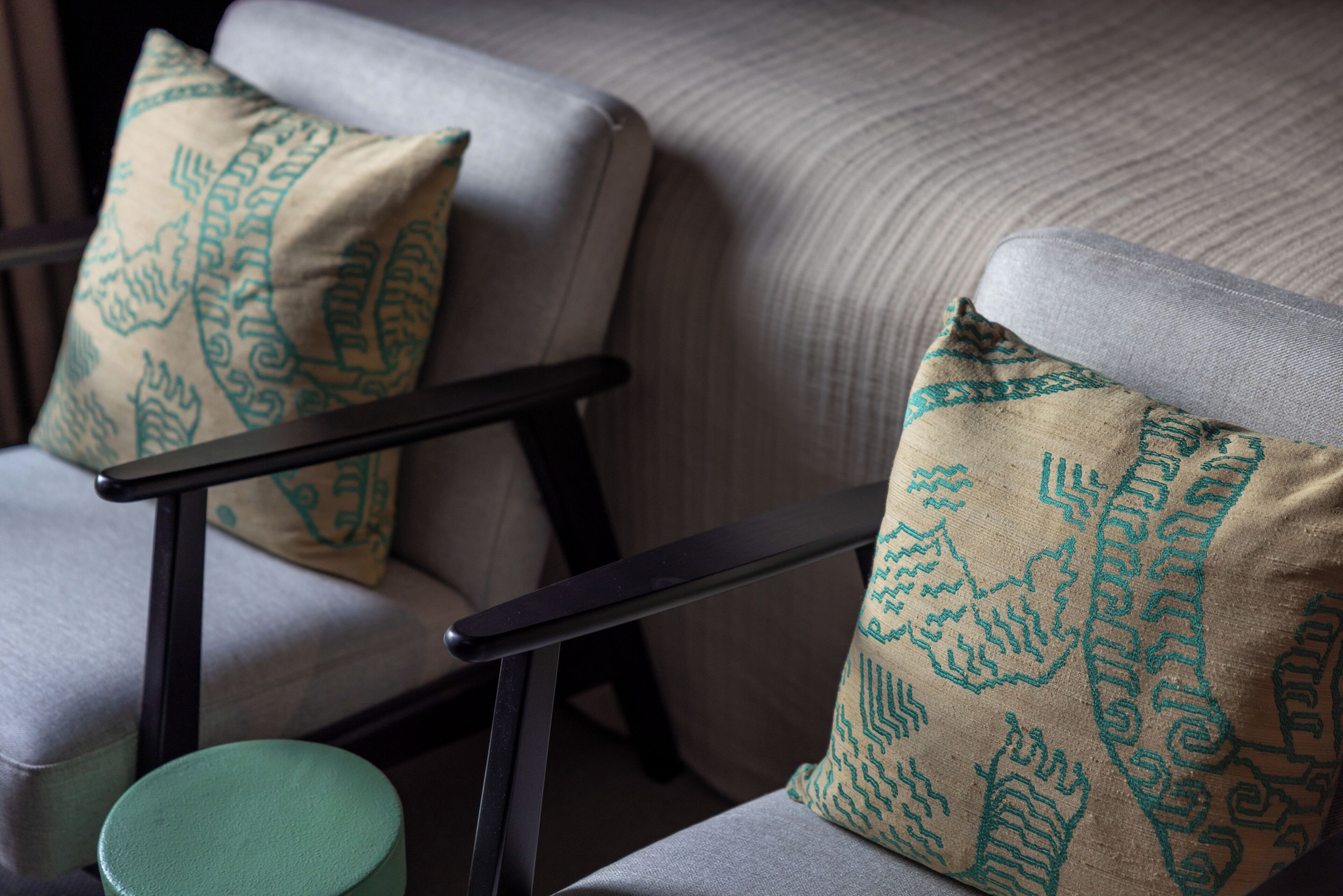 A chair with a cushion featuring a leaf pattern.