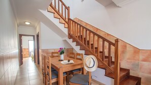 A wooden staircase with a tiled floor leading to a landing. - Casa del Mar Ilic - Communal pool, Sea Views, 10 Minutes to Marina Rubicón (Playa Blanca)