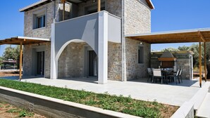 A two-story stone house with a covered patio and outdoor seating area. - Charming Villa Penelope with Private Pool walking distance to Lefkada town (Lefkada)