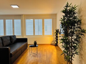 Classic Apartment, Courtyard View | Living area | Flat-screen TV - TONIGHT Apartments (Bottmingen)