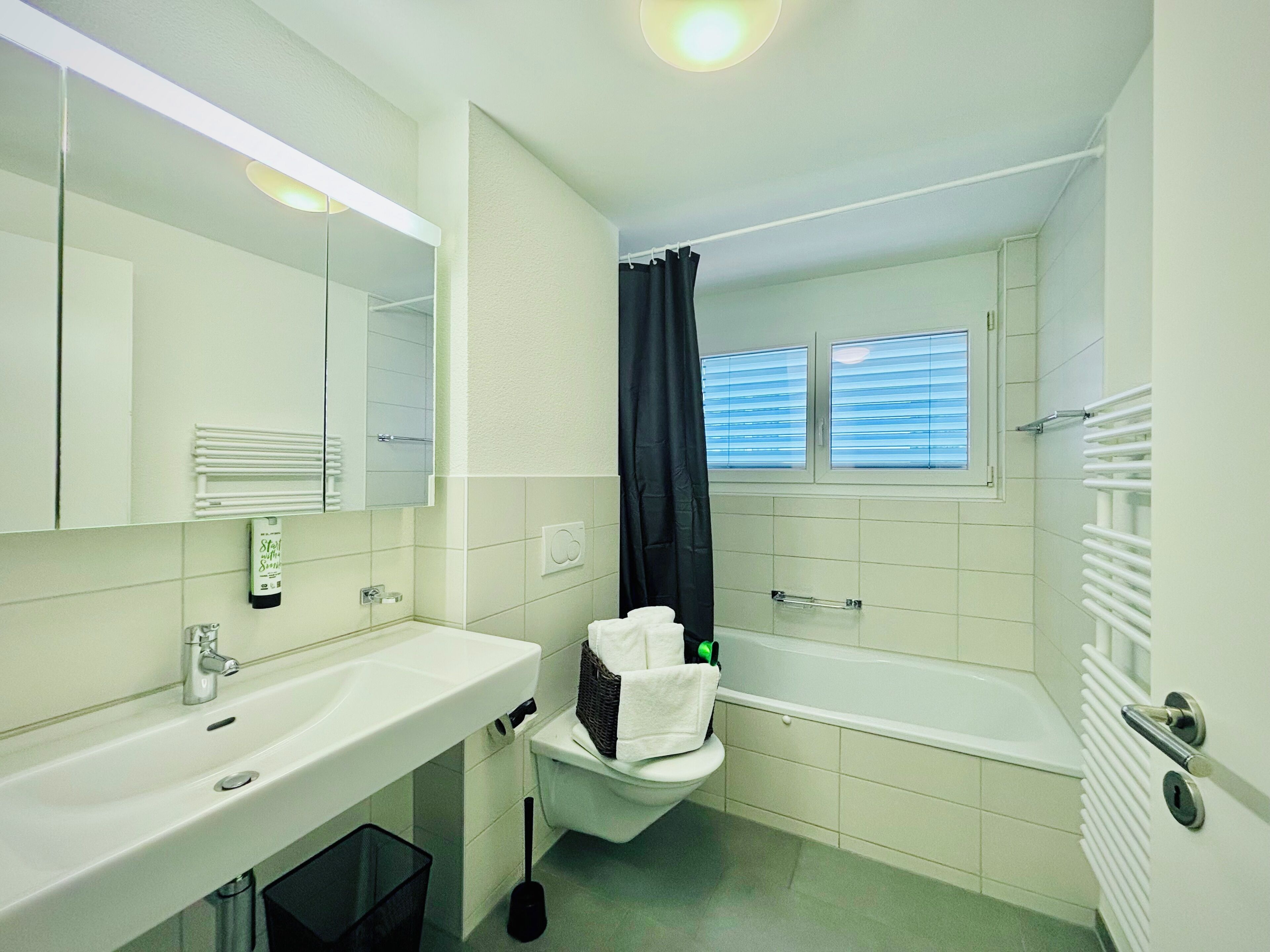 A bathroom with a sink, toilet, and bathtub.