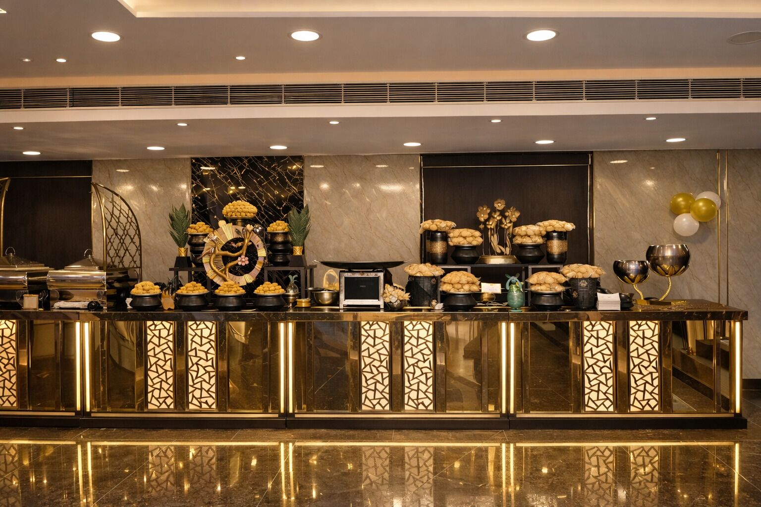 A buffet setup with a variety of food items, a decorative clock, and a modern design with geometric patterns on the counter.