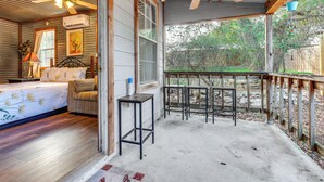 A bedroom with a bed, a chair, a desk, and a ceiling fan. - Cozy Couple's Cottage w/ View Near Canyon Lake! (Canyon Lake)