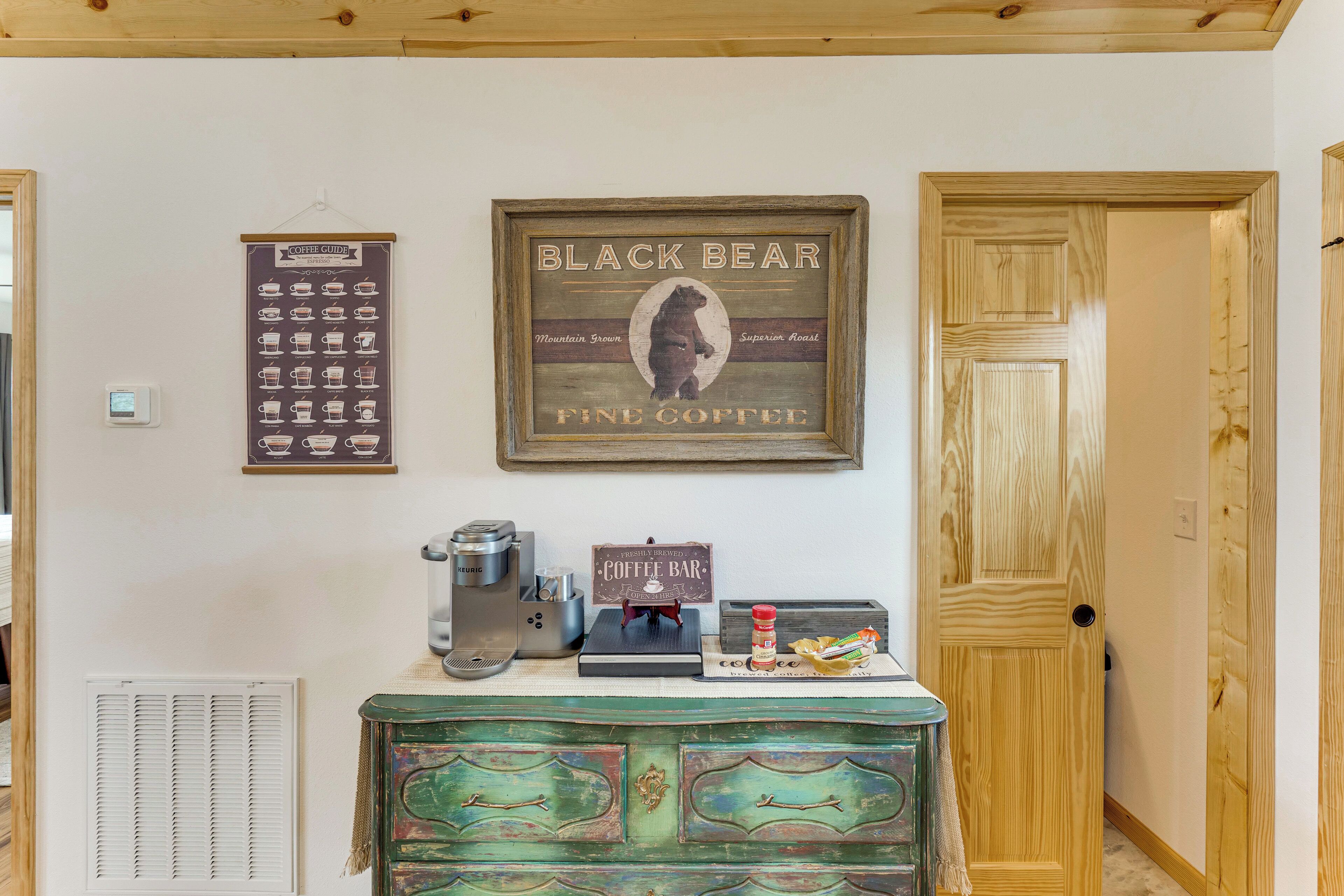 A coffee bar with a sign reading "Black Bear Fine Coffee," a coffee machine, and a coffee grinder.