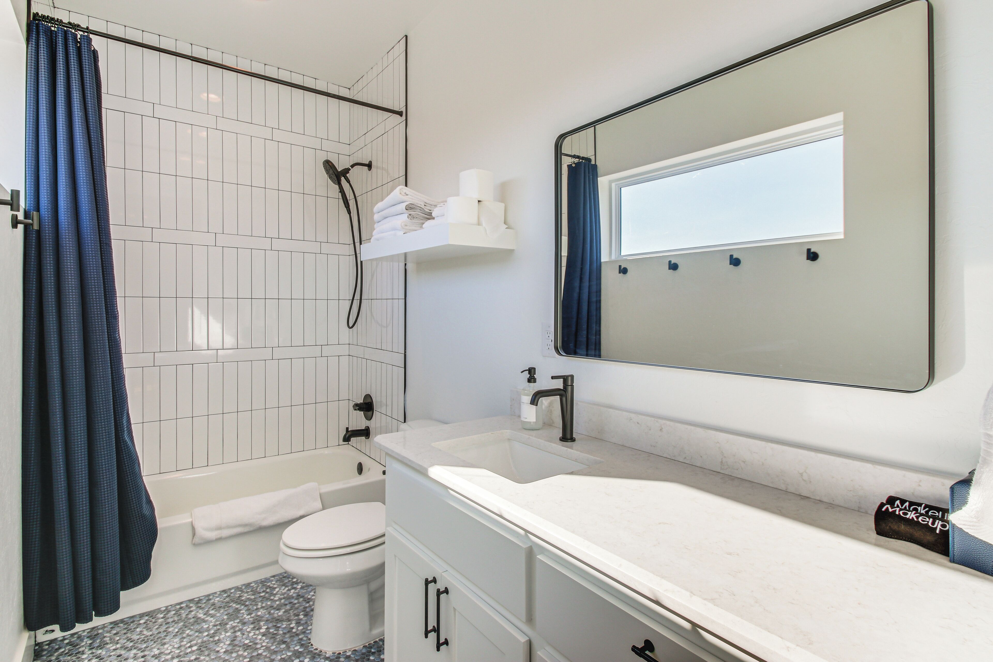 A bathroom with a bathtub, toilet, and sink.