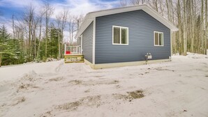 A single-story house with a gabled roof, a front porch, and a small deck. - 3 Mi to Lake Huron: Secluded Home in Rogers City (Rogers City)