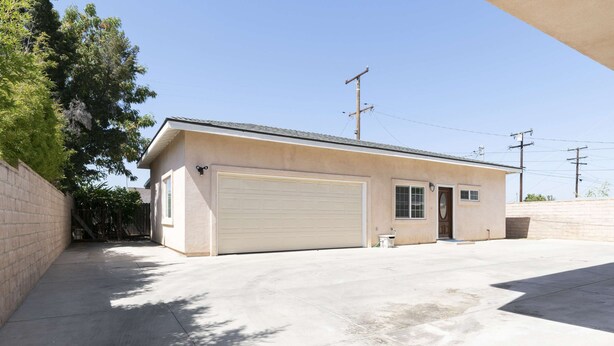 A single-story house with a garage, a small attached shed, and a paved driveway. - Elegant Retreat Modern Comforts Prime Location (Rosemead)