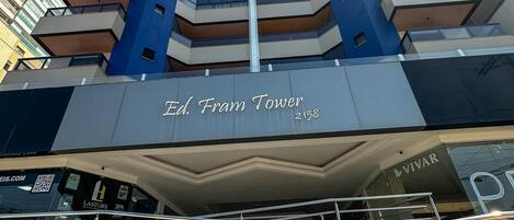 A high-rise building with a prominent 'Ed Fram Tower' sign at the entrance.