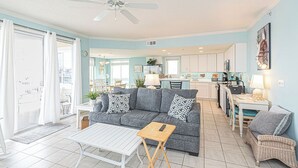 A living room with a sofa, coffee table, and a ceiling fan. - Jetty's Break-Beautiful 3 Bedroom Condo steps from the beach! (Ocean City)