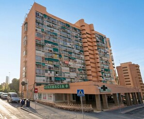A multi-story building with a pharmacy on the ground floor.
