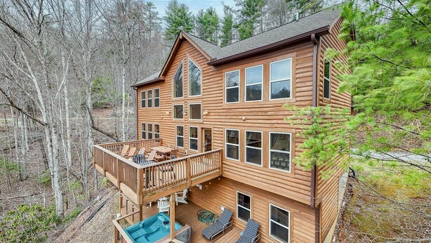 A log cabin with a deck, outdoor seating, and a hot tub. - Almond Joy Hideaway Luxury cabin, fire pit, Bryson City, Fontana Lake (Almond)