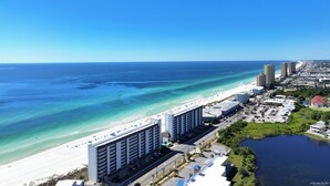 A coastal hotel with a beach view, parking, and a marina.