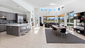 A spacious kitchen with a large island, modern appliances, and a dining area with a view.