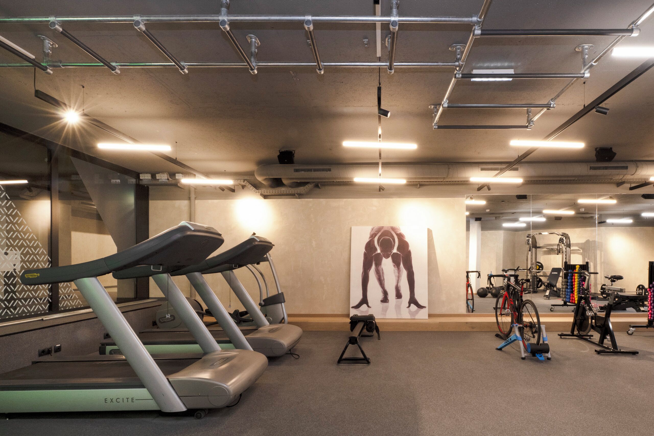 A gym with treadmills, stationary bikes, and weight machines.