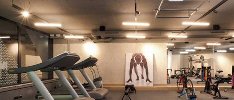 A gym with treadmills, stationary bikes, and weight machines.