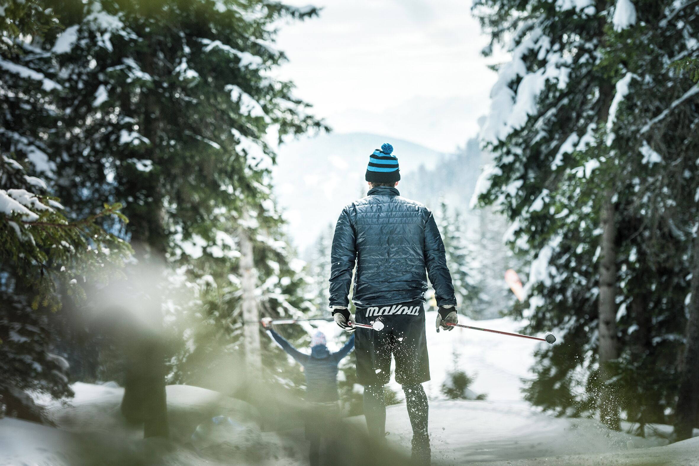 A person skiing in a snowy forest.