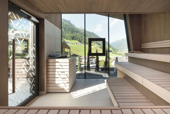 A modern interior with a large window offering a scenic mountain view. - ELVA Premium Apartment Hotel (Neustift Im Stubaital)