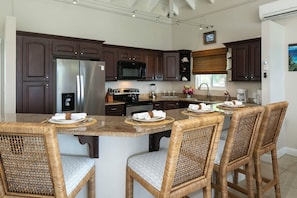 Fridge, microwave, oven, stovetop - Experience the exquisite Mango Serenity, a spacious condo that offers breathtaking views and an abundance of comfort.  Discover your perfect getaway today! (St John)