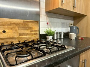 Fridge, microwave, stovetop, cookware/dishes/utensils