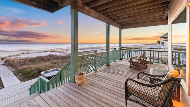A wooden deck with a view of the beach and ocean at sunset. - Gulf Front Home with Pool | Hot Tub (Port St Joe)