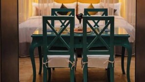 A room with a bed, a mirror, and a table with chairs. - GA PLUS (Cairo)