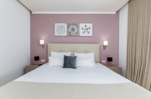 A neatly arranged bedroom with a large bed, two bedside tables, and three wall-mounted lamps. - Villa Luce Verde - beautiful villa with private pool, hot tub and sauna near the town of Porec and its beaches (Kirmenjak)