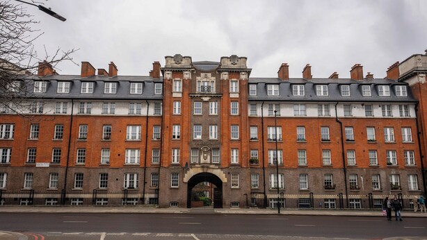 A large, historic building with a central archway, multiple windows, and a brick facade. - Stylish and cozy flat (London)