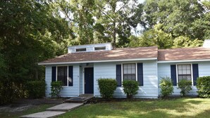 A single-story house with a front porch, a small front yard, and a driveway. - Nice 2 Bedroom Duplex Great For Contractors (Saint Mary's)