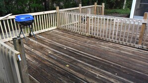 A wooden deck with a barbecue grill and a wooden fence. - Nice 2 Bedroom Duplex Great For Contractors (Saint Mary's)